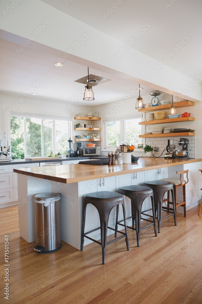 Bright modern kitchen with wood bar and open shelving Bright modern kitchen with wood bar and open shelving