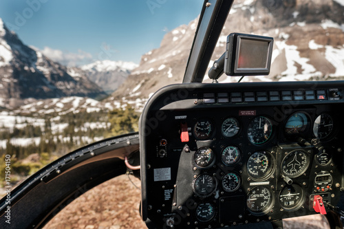 Cockpit of a helicopter landed in a meadow in the Rocky Mountains