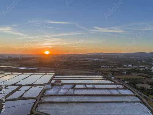 Sunset aerial view  in Ria Formosa wetlands natural park  salt production pans in the foreground  Algarve.