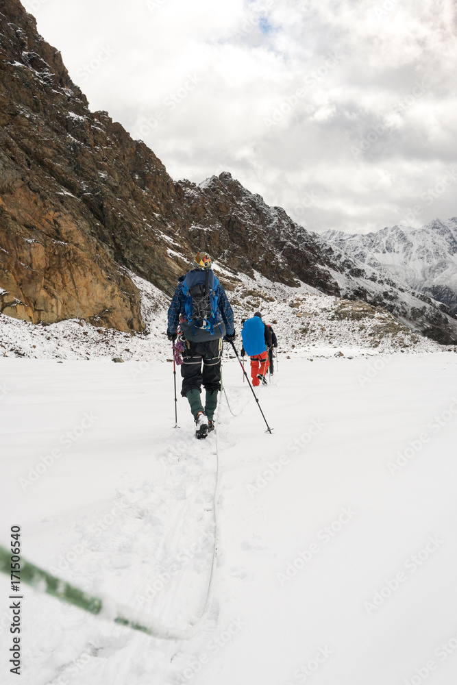 Two alpinists walking on a glacier in the alps. Two alpinists walking on a glacier in the alps.