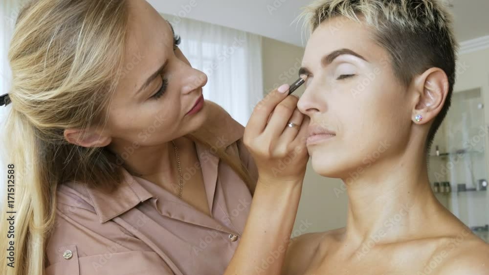 Makeup Specialist artist makes a blonde woman model beautiful Gentle makeup before an important event. step by step Makeup Specialist artist makes a blonde woman model beautiful Gentle makeup before an important event. step by step