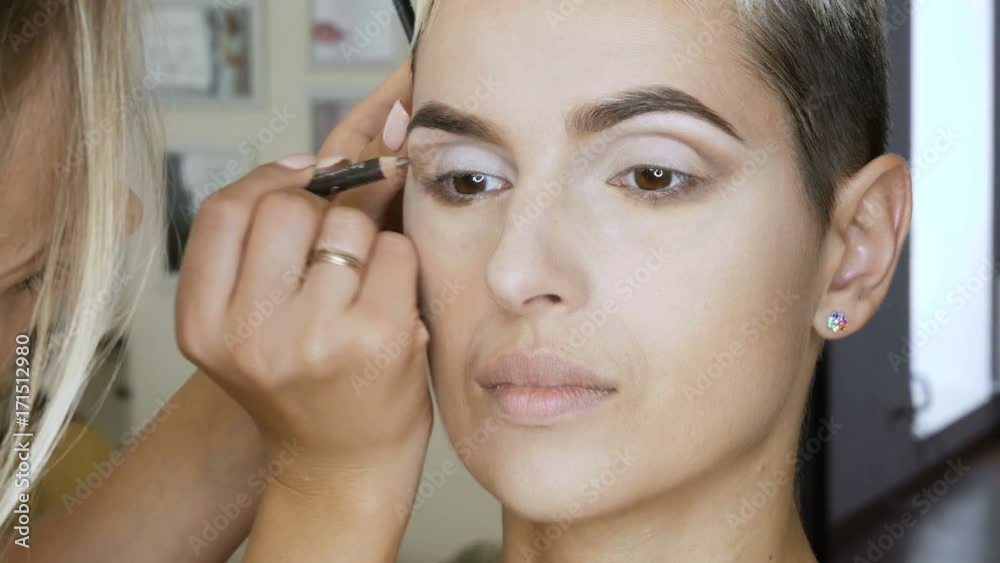 Makeup Specialist artist makes a blonde woman model beautiful Gentle makeup before an important event. step by step Makeup Specialist artist makes a blonde woman model beautiful Gentle makeup before an important event. step by step