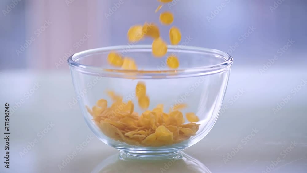 Cereal corn flakes pouring into bowl HD slow-motion video. Morning breakfast food cornflakes Cereal corn flakes pouring into bowl HD slow-motion video. Morning breakfast food cornflakes
