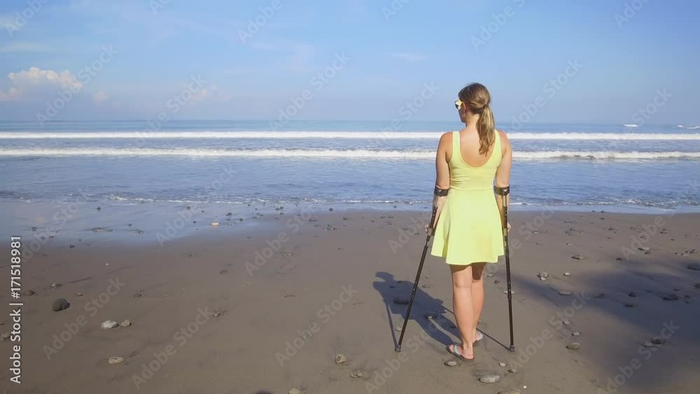 CLOSE UP Carefree strong independent woman traveling with crutches on