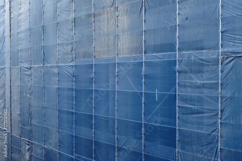 background or texture of under construction high-rise building with scaffold system