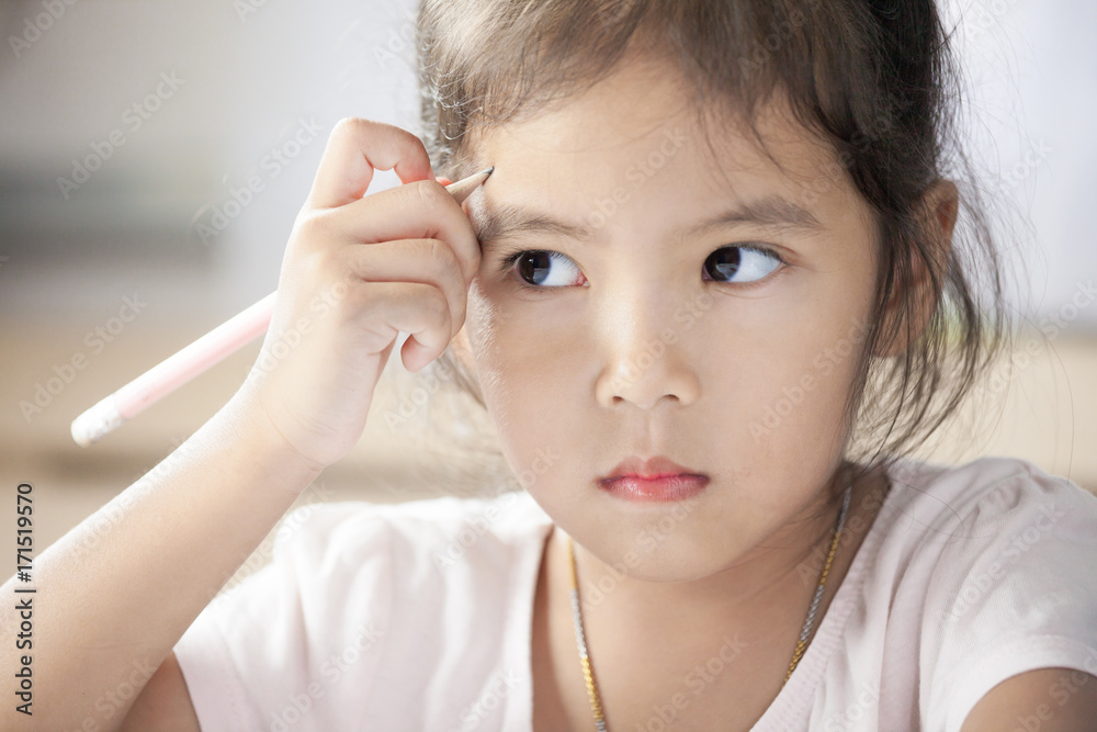 Portrait of cute asian child girl thinking and having fun to draw and paint in the room Portrait of cute asian child girl thinking and having fun to draw and paint in the room