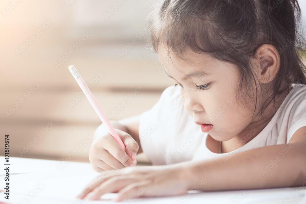 Cute asian child girl having fun to draw and paint with crayon in vintage color tone Cute asian child girl having fun to draw and paint with crayon in vintage color tone