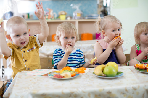 little kids eating in kindergarten