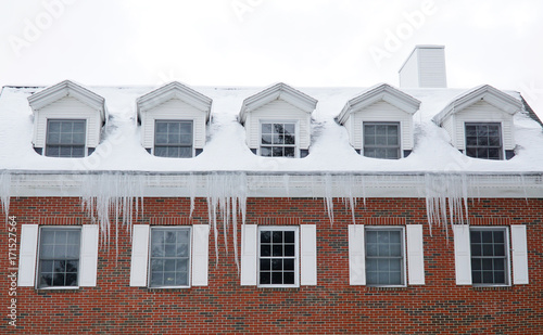 Facade view of old apartment building with icicle from roof