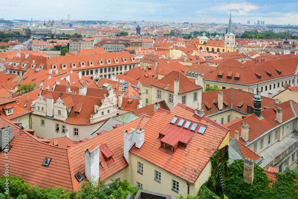 The old town's ceramic tiles rooftops, Prague, Czech Republic. Red Shingles Roof with attic and  skylights windows. Typical Architecture of Czech Republic, Prague.