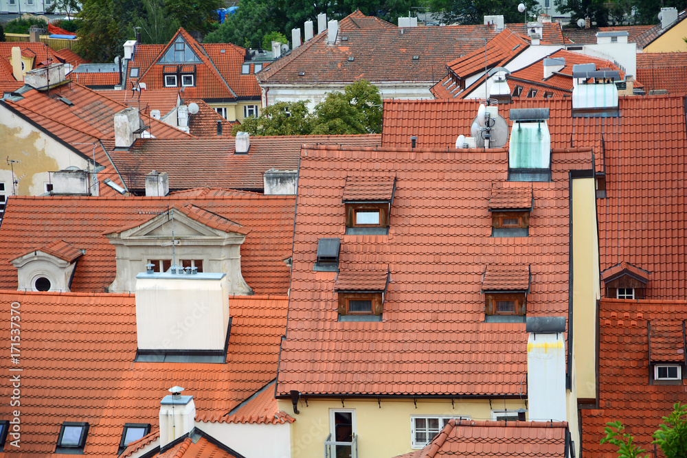 The old town's ceramic tiles rooftops, Prague, Czech Republic. Red Shingles Roof with attic and  skylights windows.