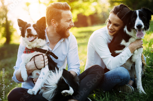 Photography Romantic couple in love walking dogs in nature and smiling