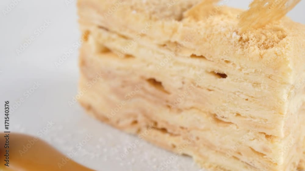Vanilla or custard slice cake, served with icingsugar and raspberry, close-up view, loop, 4K, ProRes codec, 422 HQ, ISO 100 Vanilla or custard slice cake, served with icingsugar and raspberry, close-up view, loop, 4K, ProRes codec, 422 HQ, ISO 100