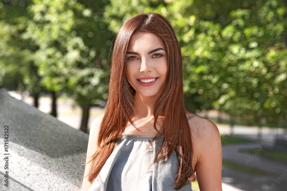 Beautiful young woman outdoors on sunny day