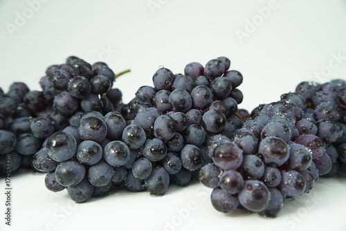 branches of blue grapes isolated on white background