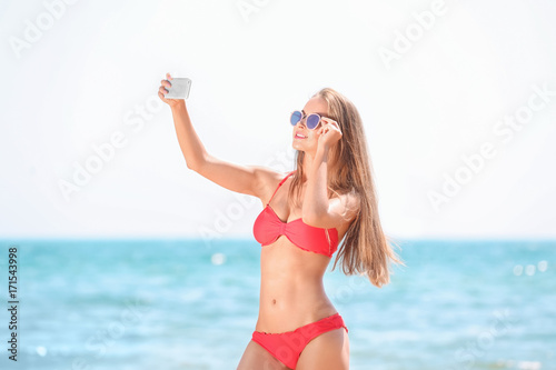 Beautiful young woman takin...
