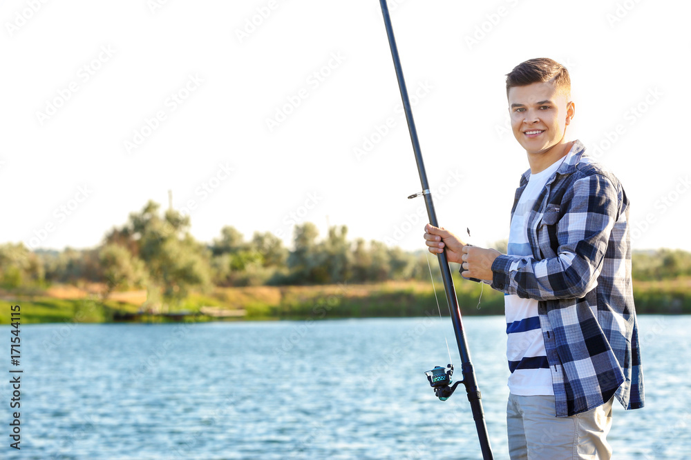 Young man fishing on river Young man fishing on river