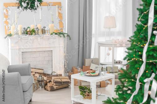 Decorated Christmas room with beautiful fir tree © Africa Studio
