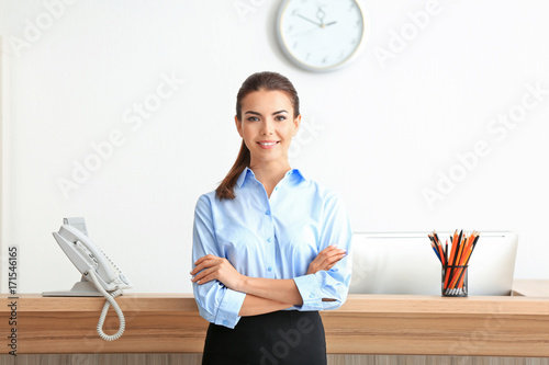 Young female receptionist working in office photo