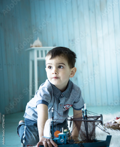 boy playing with a boat