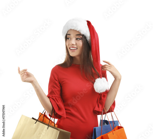 Young woman in Santa hat ho...