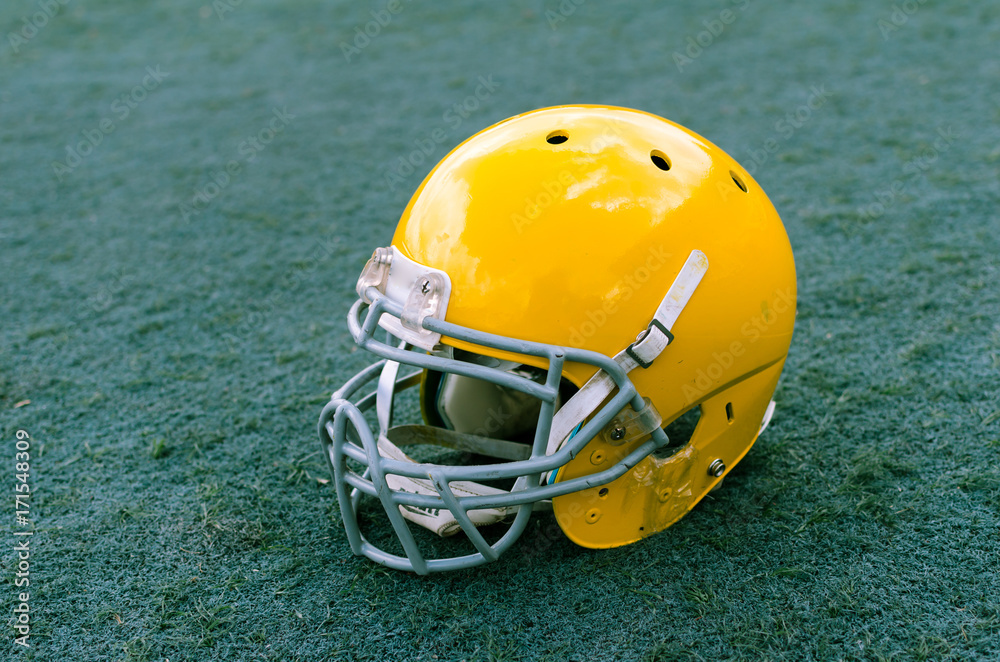 Fototapeta premium Stadium grass with football helmet on it