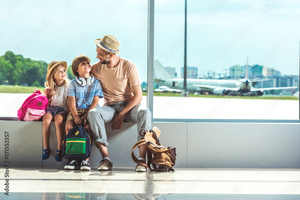 father and kids waiting for boarding father and kids waiting for boarding
