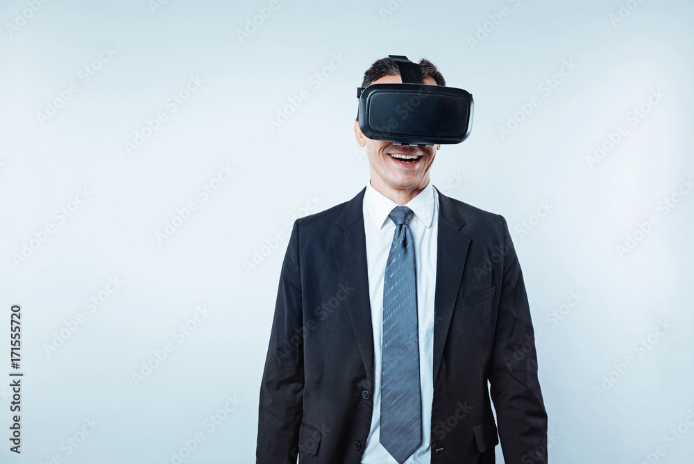 Happy male entrepreneur wearing virtual reality goggles Happy male entrepreneur wearing virtual reality goggles