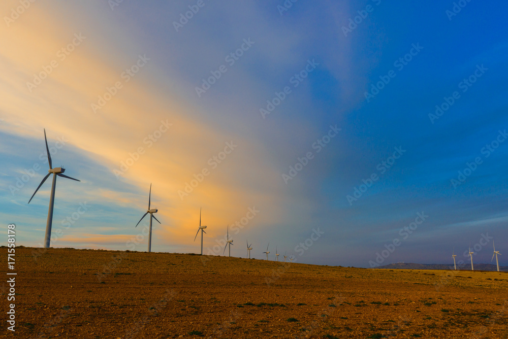 Wind turbines farm at sunset, Saragossa, Spain Wind turbines farm at sunset, Saragossa, Spain