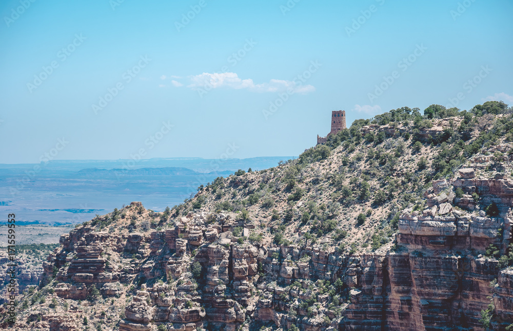 Watch tower on the Grand Canyon cliff against the blue sky