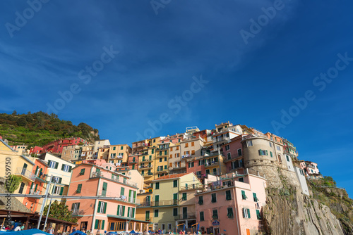 Magnificent daily view of the Manarola village in a sunny summer day. Manarola is one of the five famous villages in Cinque Terre (Five lands) National Park. Liguria, Italy, Europe