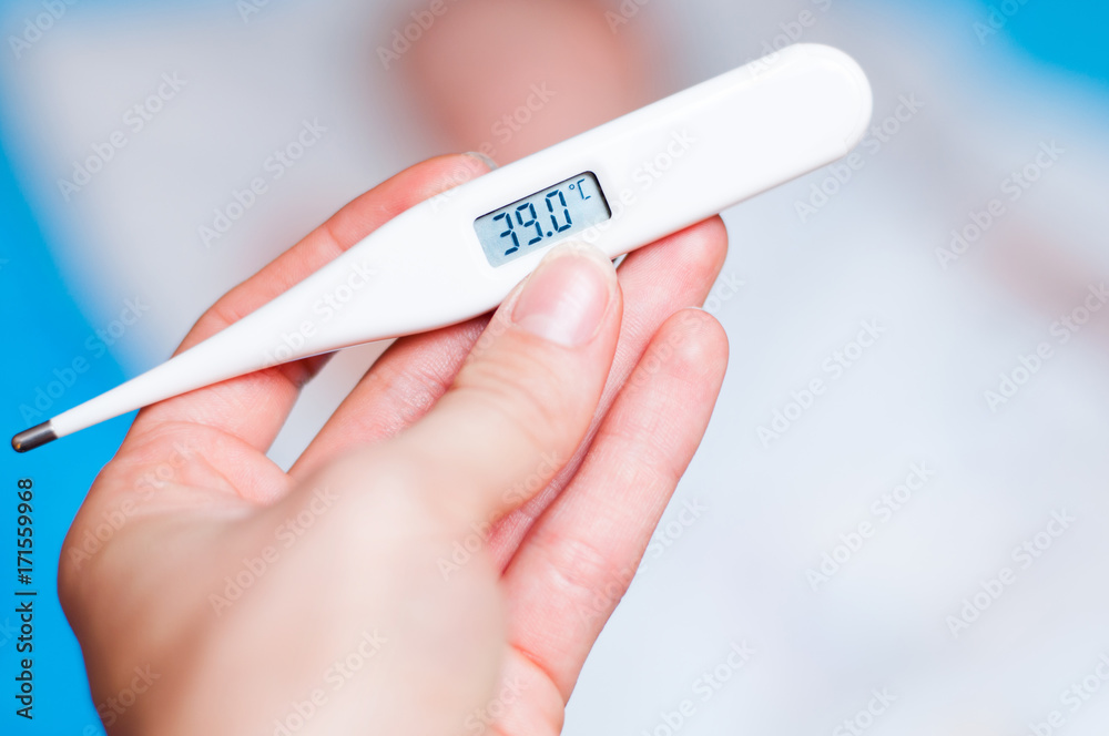The Hand Holds A Thermometer With 38 2 Degrees Celsius On The Background Of The Child Sleeping In Bed Stock Photo Adobe Stock
