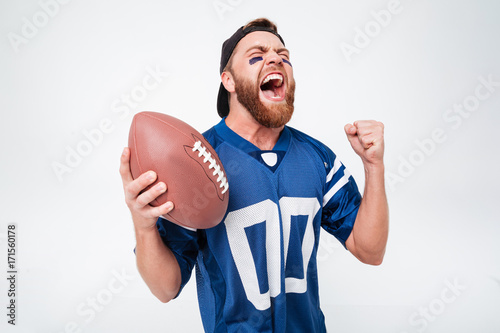 Excited screaming man fan holding rugby ball. photo
