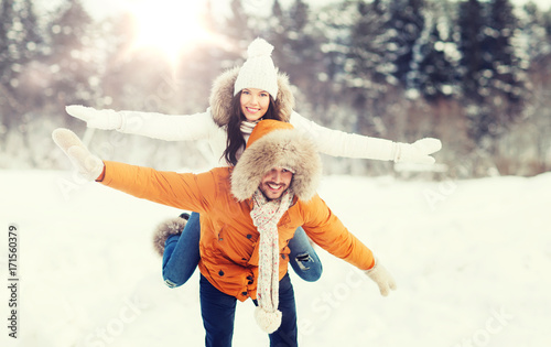 happy couple having fun over winter background