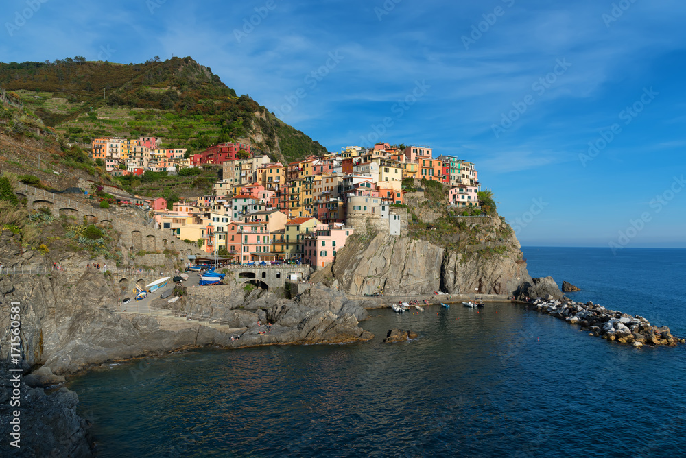 Magnificent daily view of the Manarola village in a sunny summer day. Manarola is one of the five famous villages in Cinque Terre (Five lands) National Park. Liguria, Italy, Europe