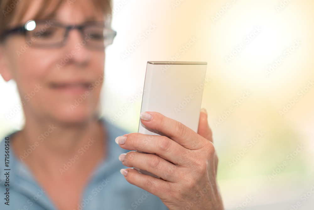 Hand of woman holding her mobile phone, light effect Hand of woman holding her mobile phone, light effect