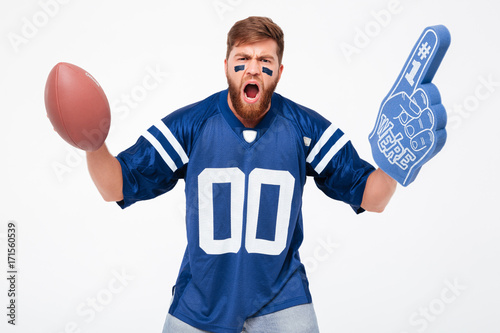 Excited man with rugby ball and fan finger cheering up isolated