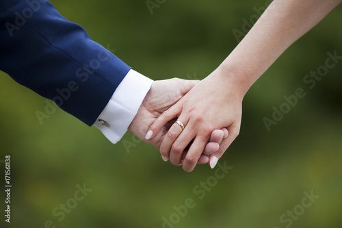 Wedding couple holding hands 