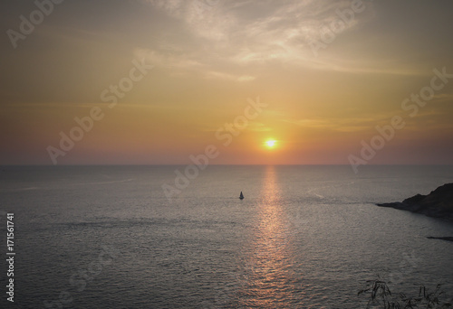 Sailing boat at sunset © KHOMSAN