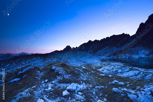 night sky with moon over rocky mountains