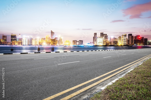 empty asphalt road with modern buildings in blue sky