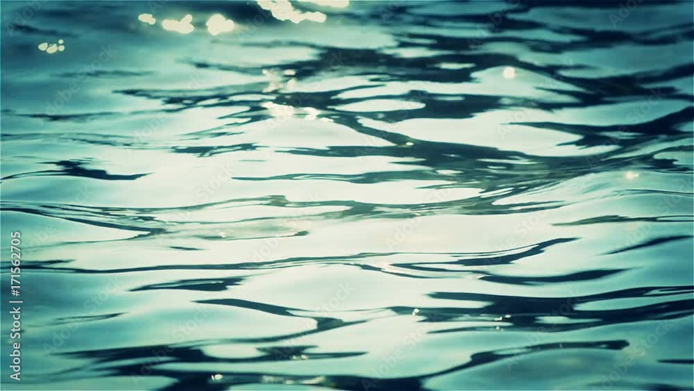 The calm sea surface slowly waves in the afternoon summer sun. Recorded with a telephoto lens and represents only a small part of the water surface. The calm sea surface slowly waves in the afternoon summer sun. Recorded with a telephoto lens and represents only a small part of the water surface.