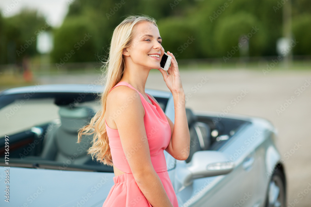 woman calling on smartphone at convertible car