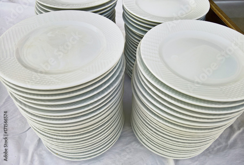 Stack of porcelain plates and bowls in restaurant