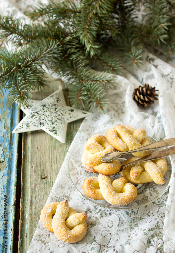 Pretzel with sugar in a New Year or Christmas decoration. Rustic style, selective focus.