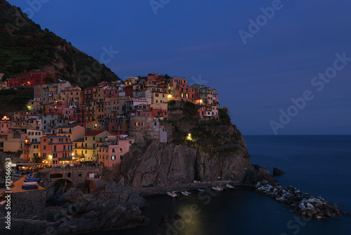 Stunning view of the beautiful and cozy village of Manarola in the Cinque Terre National Park at night. Liguria, Italy.