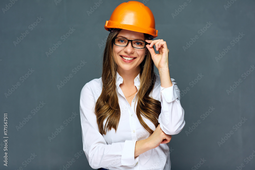 Smiling woman engineer wearing builder helmet.