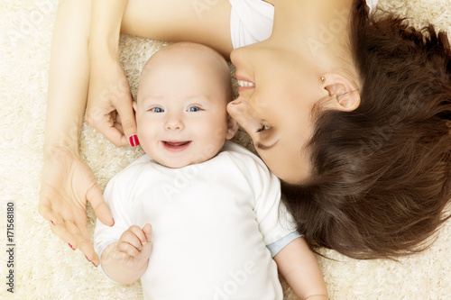Baby and Mother, Happy Mom with six months Kid Boy, top view in bed