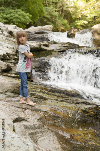 Girl next to the Waterfall of the bucket in the Selva de Irati in Navarra  Spain.