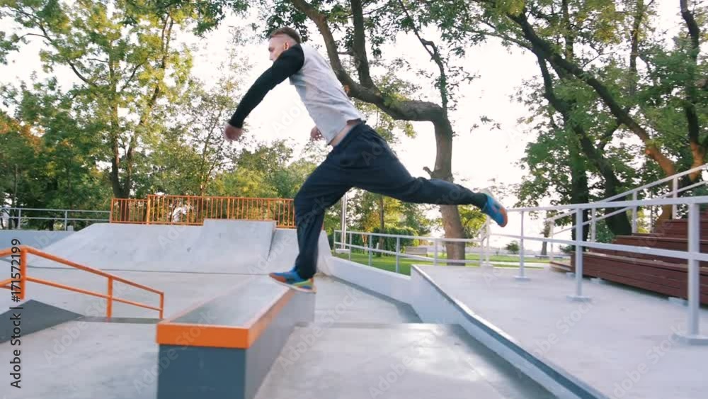 Young man doing parkour tricks in extreme sports park